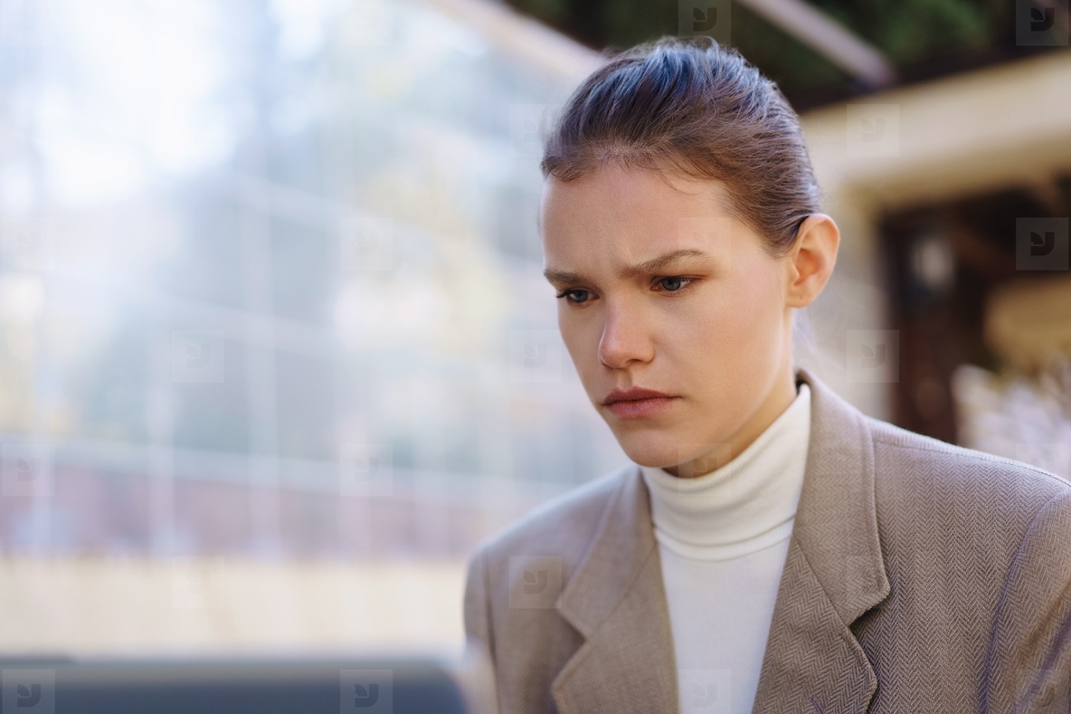A contemplative woman is captured in an urban environment  showcasing her depth and beauty