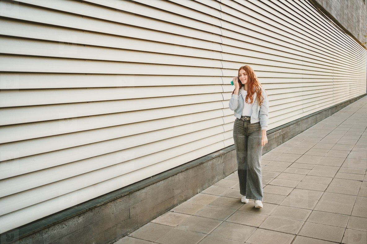 A relaxed and informal street style portrait of a woman captured in an urban setting