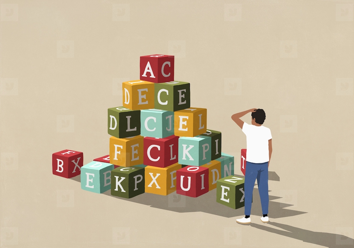 Confused man looking at stack of alphabet blocks