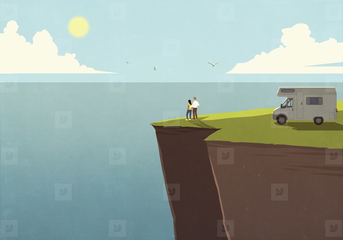 Couple on vacation standing outside RV enjoying sunny ocean view from cliff