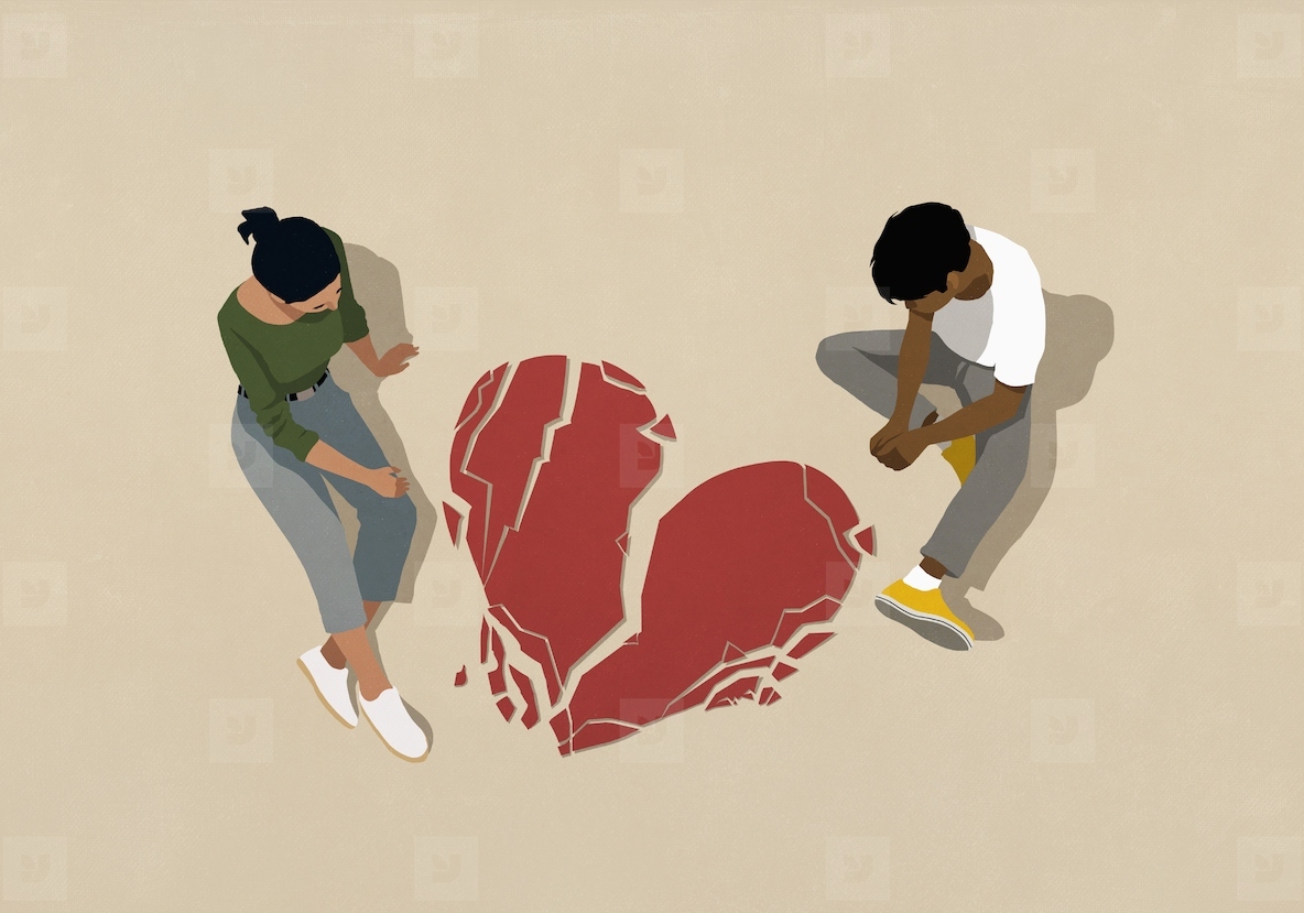 High angle view couple looking down at broken heart on beige background