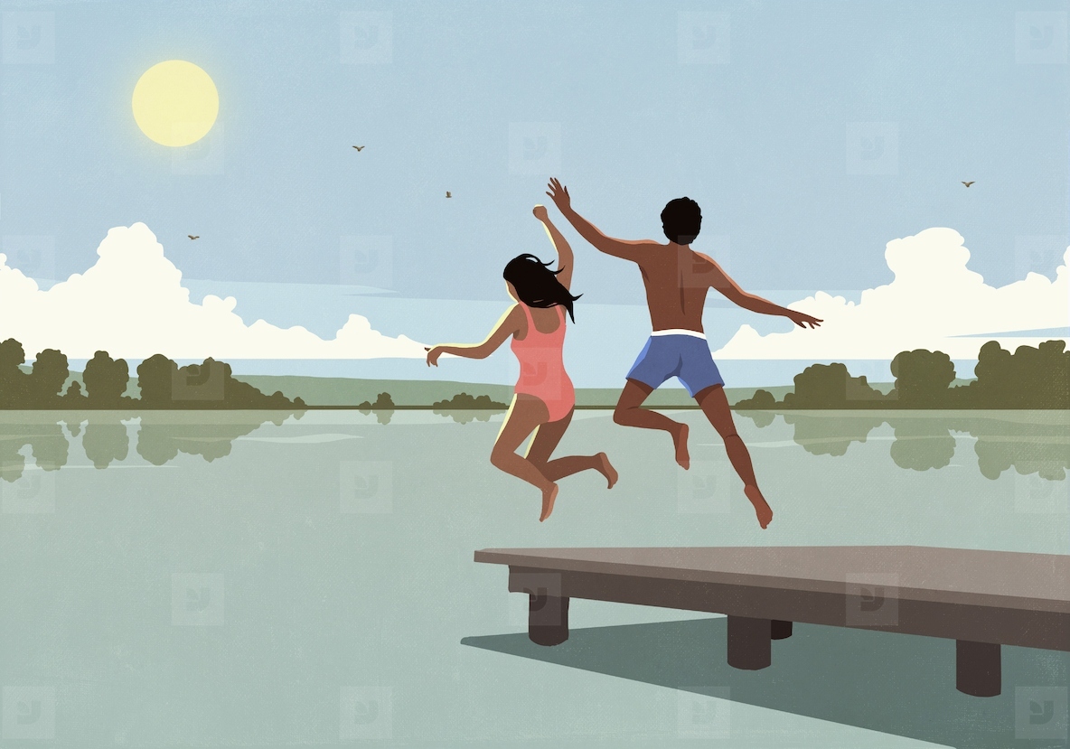 Carefree couple running and jumping off dock over sunny summer lake