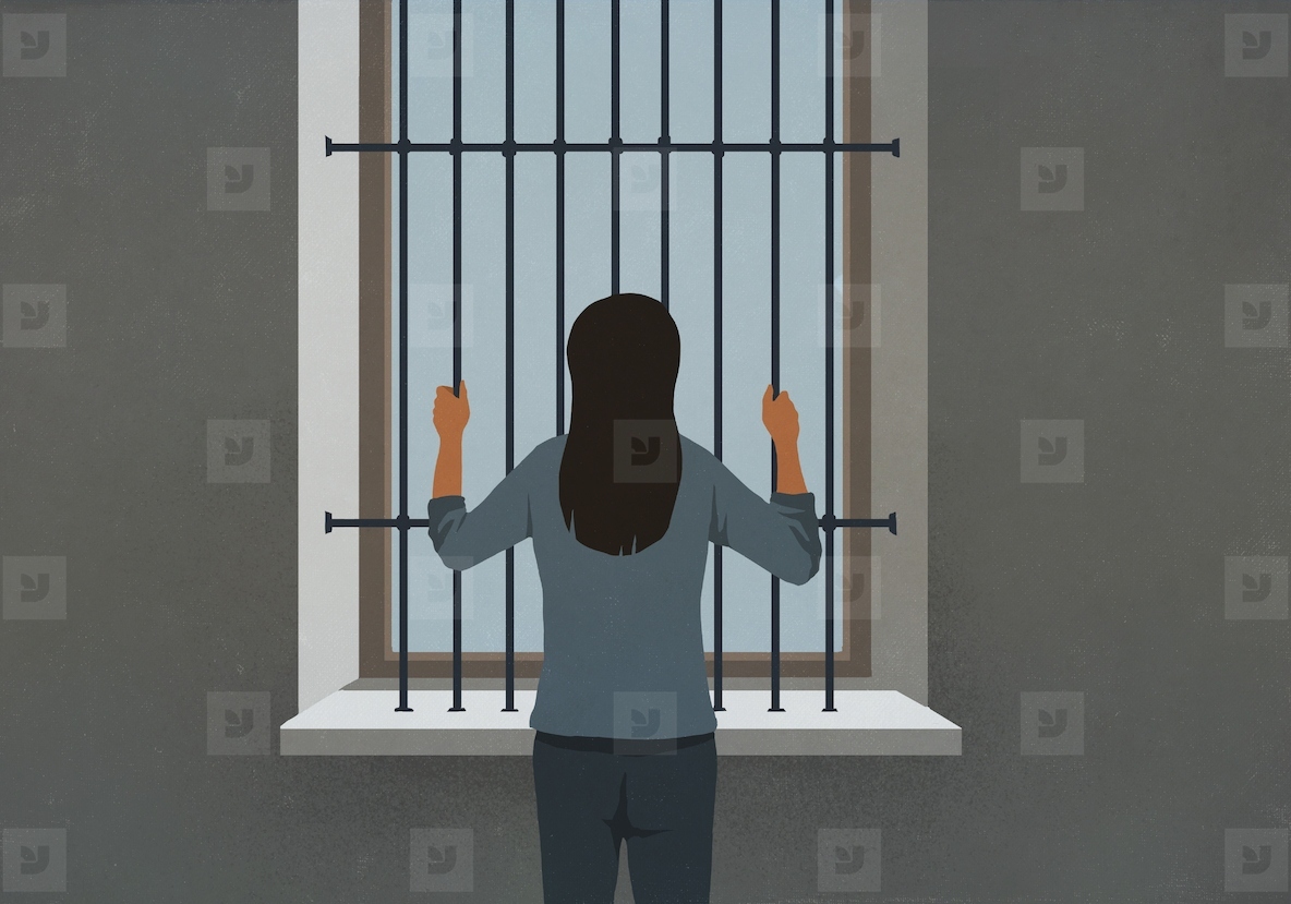 Woman standing behind bars looking out window