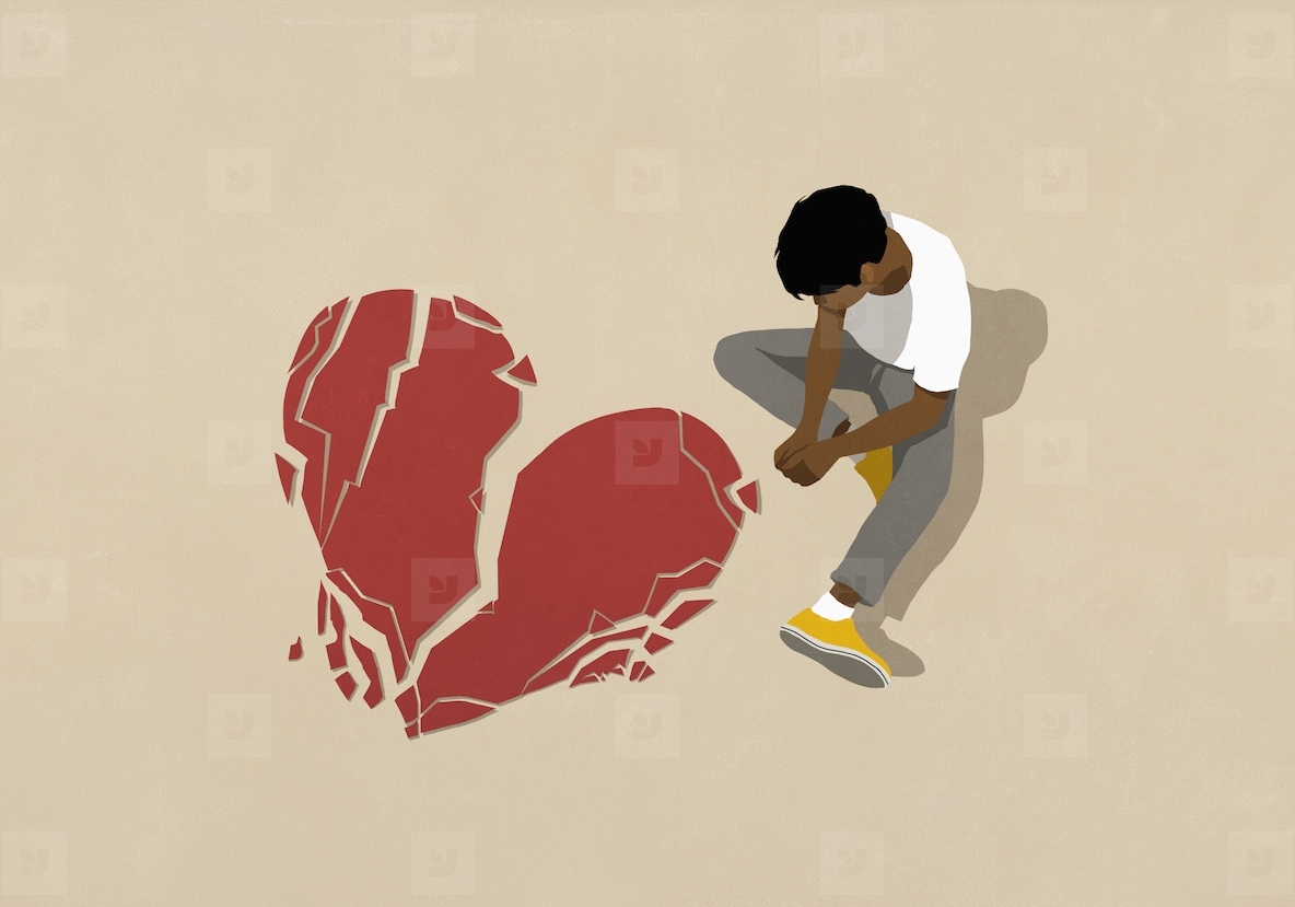 High angle view sad man looking down at broken heart