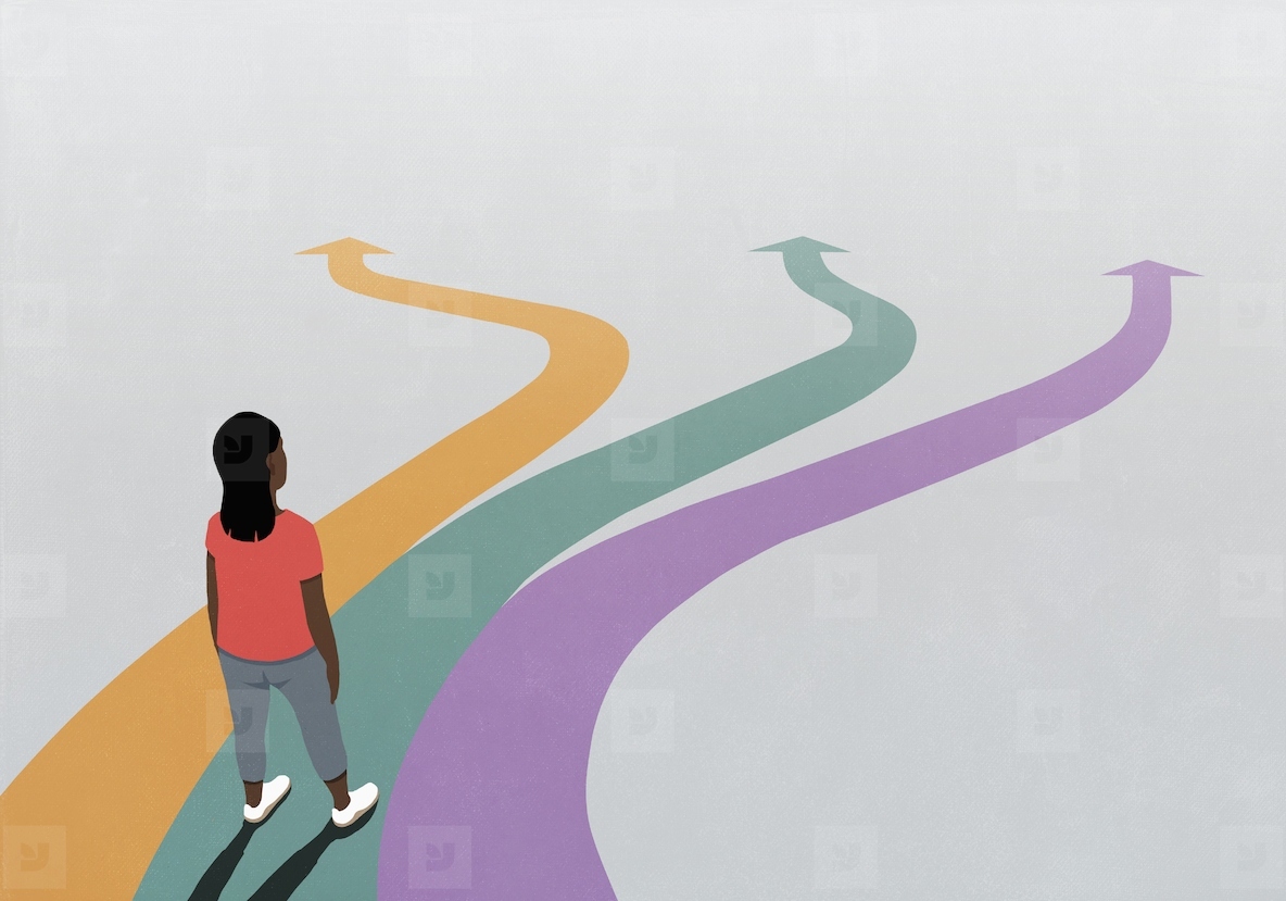 Woman looking down at multicolored arrow paths extending in front of her