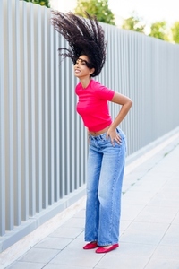 Dynamic Fashion Photoshoot Featuring a Model in a Trendy Outfit with Stylish Hair Movement