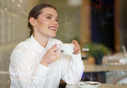 Beauty businesswoman enjoying morning coffee in a coffee shop Beauty businesswoman enjoying morning coffee in a coffee shop
