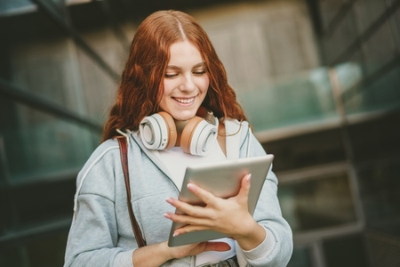 A Teen Girl Relishing the Joy of Music and Technology in a Dynamic Urban Environment
