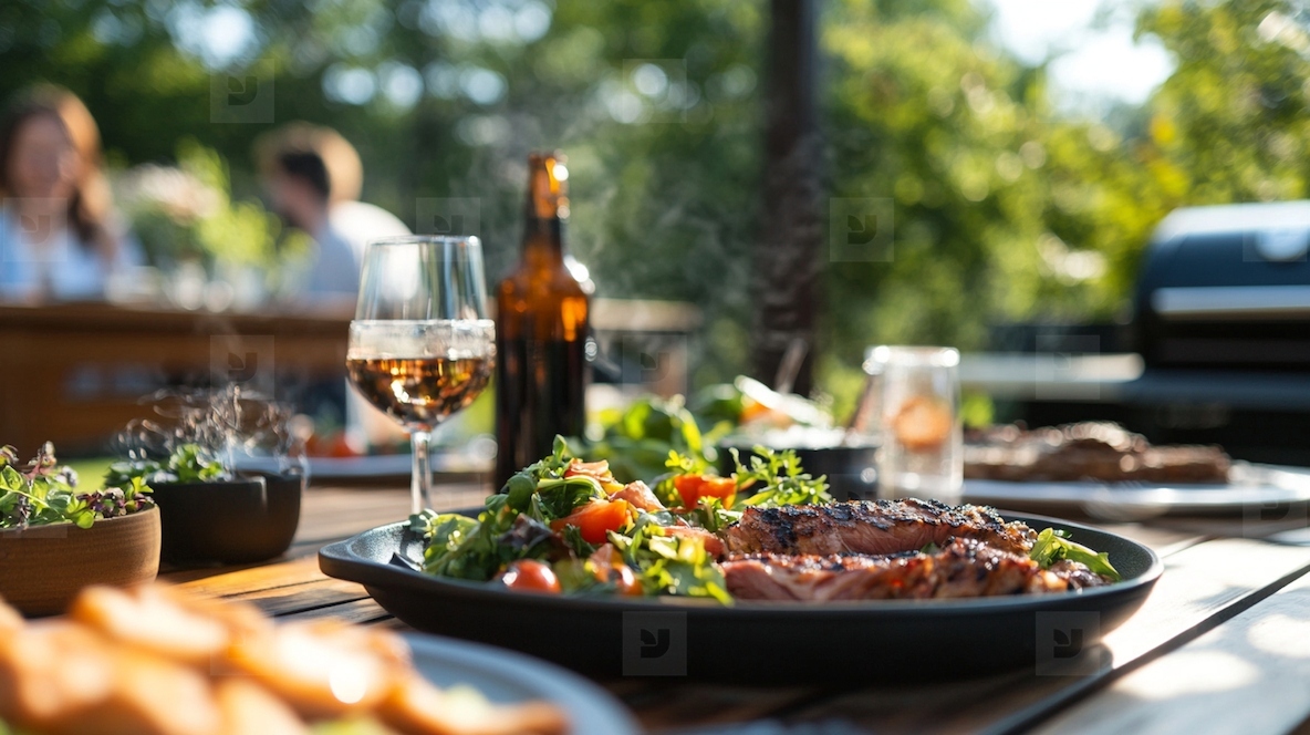 summer feast on outdoor dining table with grilled meat and salad