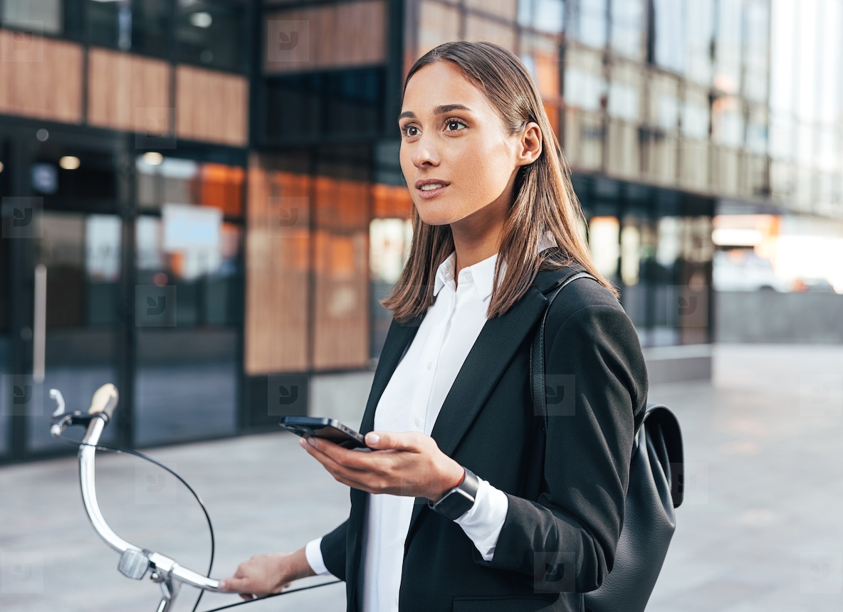 Portrait of young businesswoman with mobile phone and bicycle  Young entrepreneur with backpack and bicycle