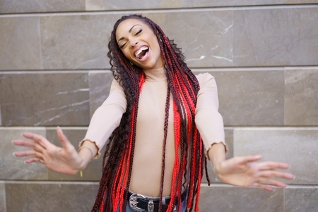 A Joyful Woman with Beautiful Braided Hair Expressing Unmatched Happiness and Positivity