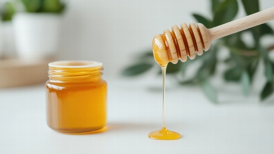 Golden honey drips from wooden dipper into jar creating sweet and natural scene Golden honey drips from wooden dipper into jar creating sweet and natural scene