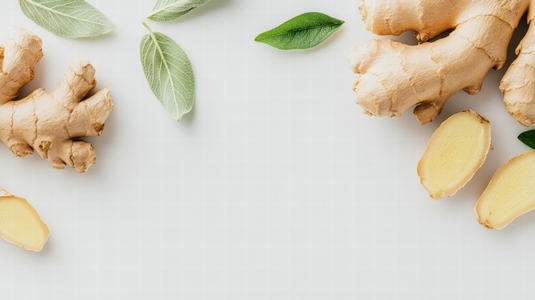 Fresh ginger root and slices with green leaves on white background Fresh ginger root and slices with green leaves on white background