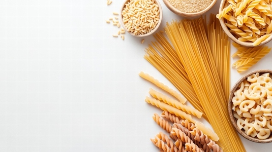variety of dried pasta neatly arranged on white background