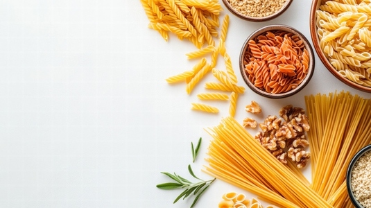 variety of dried pasta and ingredients are neatly arranged on white background