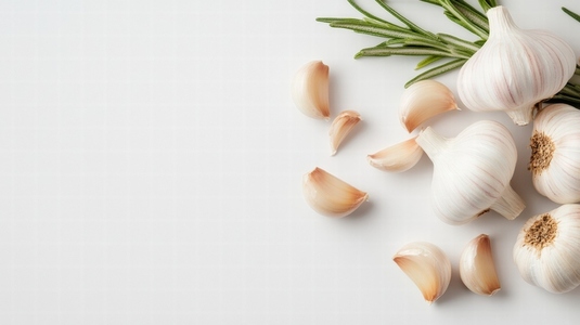 Fresh garlic cloves and rosemary on white background