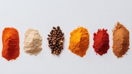 Colorful spices in neat piles on white background