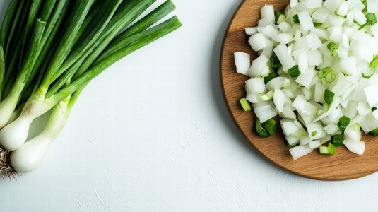 Fresh green onions and diced onions on wooden board