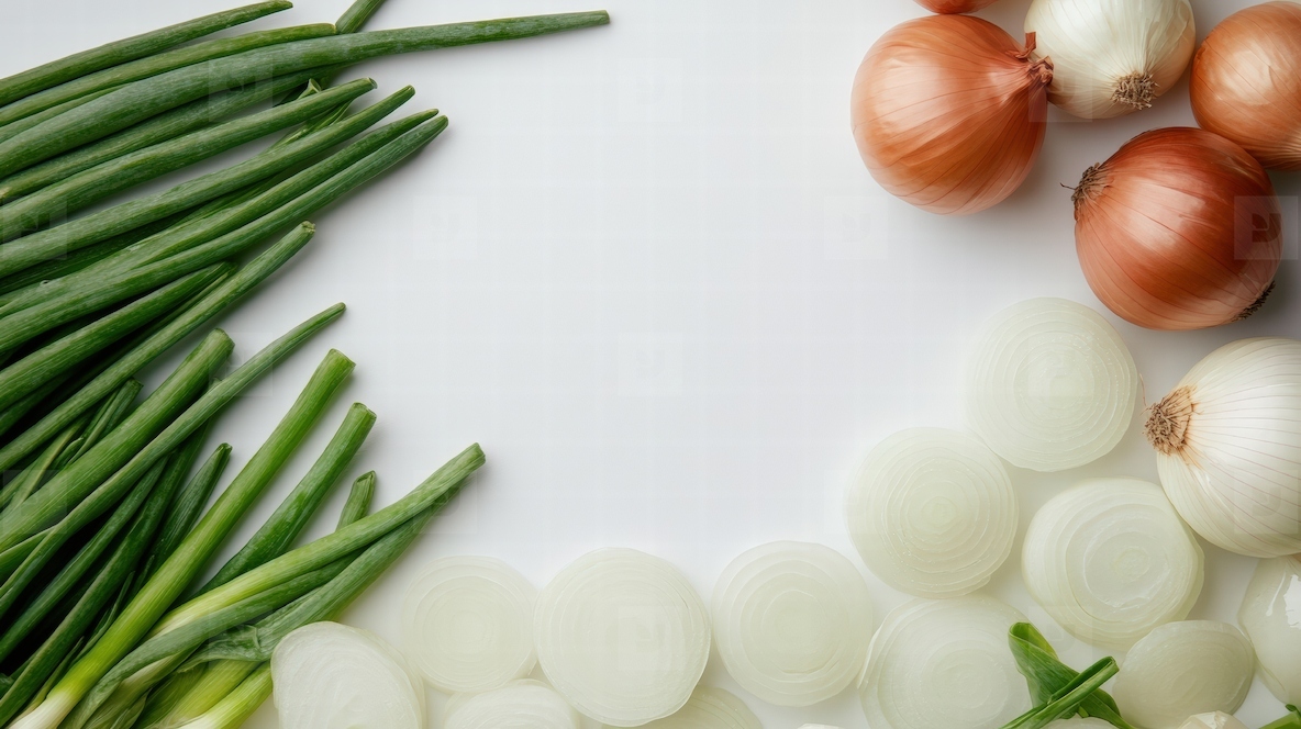 Fresh green onions and sliced white onions on white surface