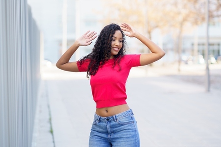 A Joyful Young Woman in a Stylish Outfit Posing Outdoors with Natural Scenic Beauty A Joyful Young Woman in a Stylish Outfit Posing Outdoors with Natural Scenic Beauty
