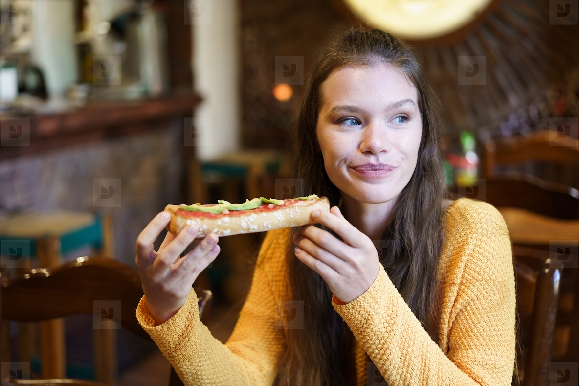Savoring a Truly Delicious Slice of Pizza While Enjoying a Warm and Cozy Restaurant Atmosphere