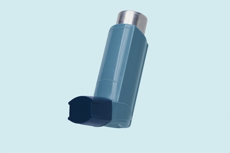 Close up still life of blue inhaler on blue background Close up still life of blue inhaler on blue background