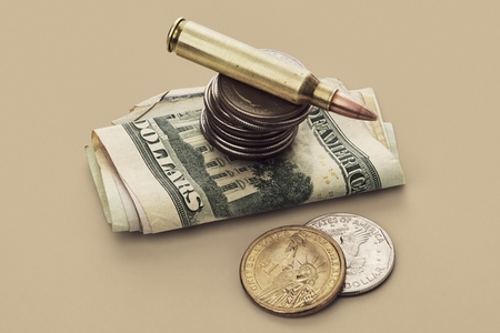 US Defense Spending bullet cartridge and coins