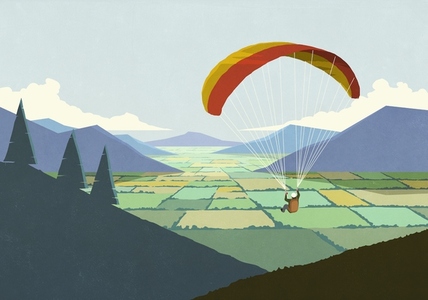 Parachuter descending over scenic rural mountain valley landscape