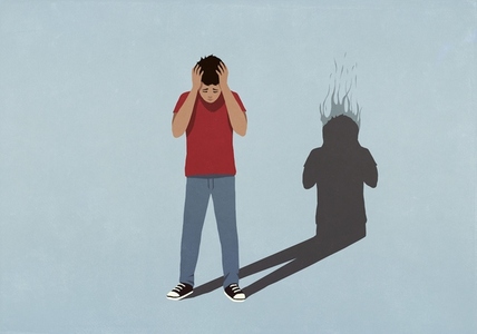 Shadow with burning head behind frustrated boy with head in hands