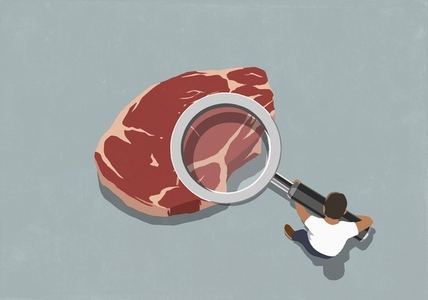 View from above man holding magnifying glass over raw steak meat