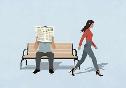 Man on bench peering through holes in newspaper