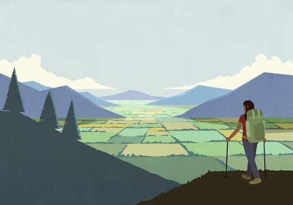 Woman backpacking enjoying scenic rural landscape view of mountain valley