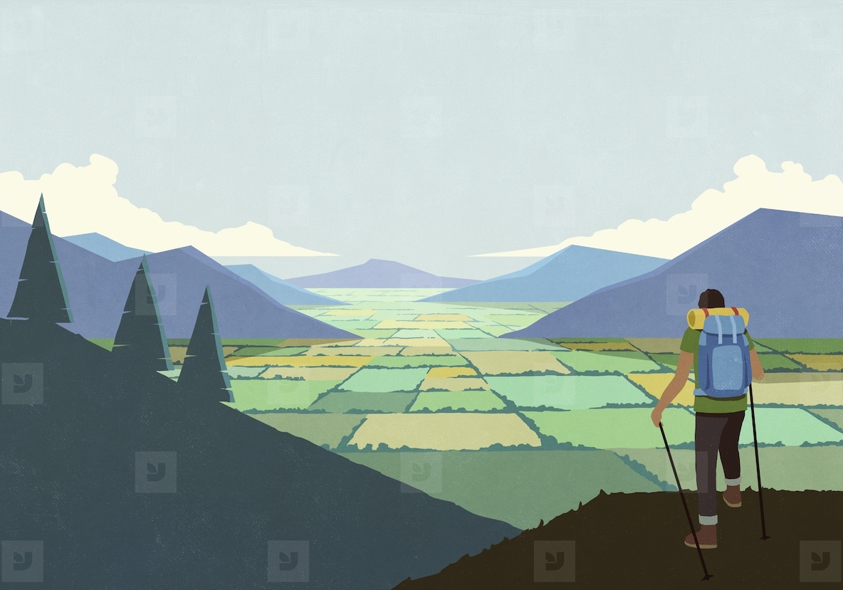 Man backpacking in nature looking at scenic mountain valley landscape view