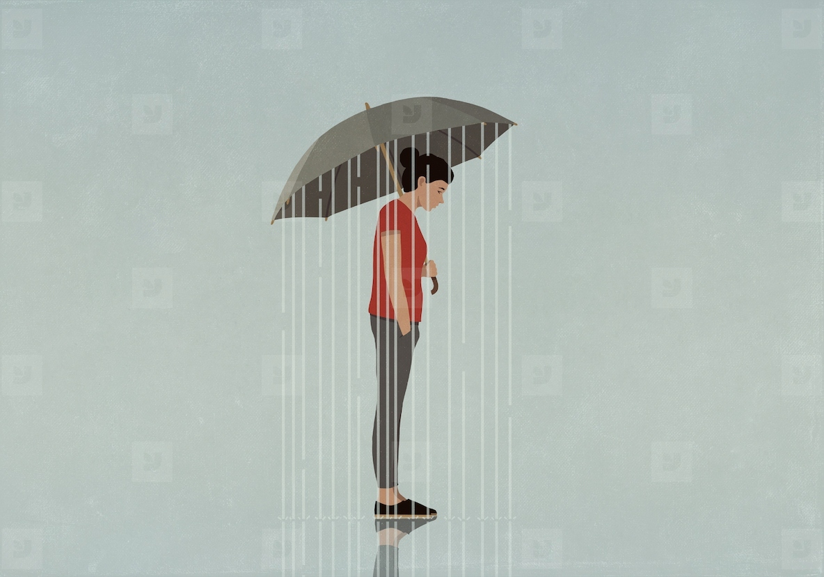 Rain falling from umbrella over depressed woman