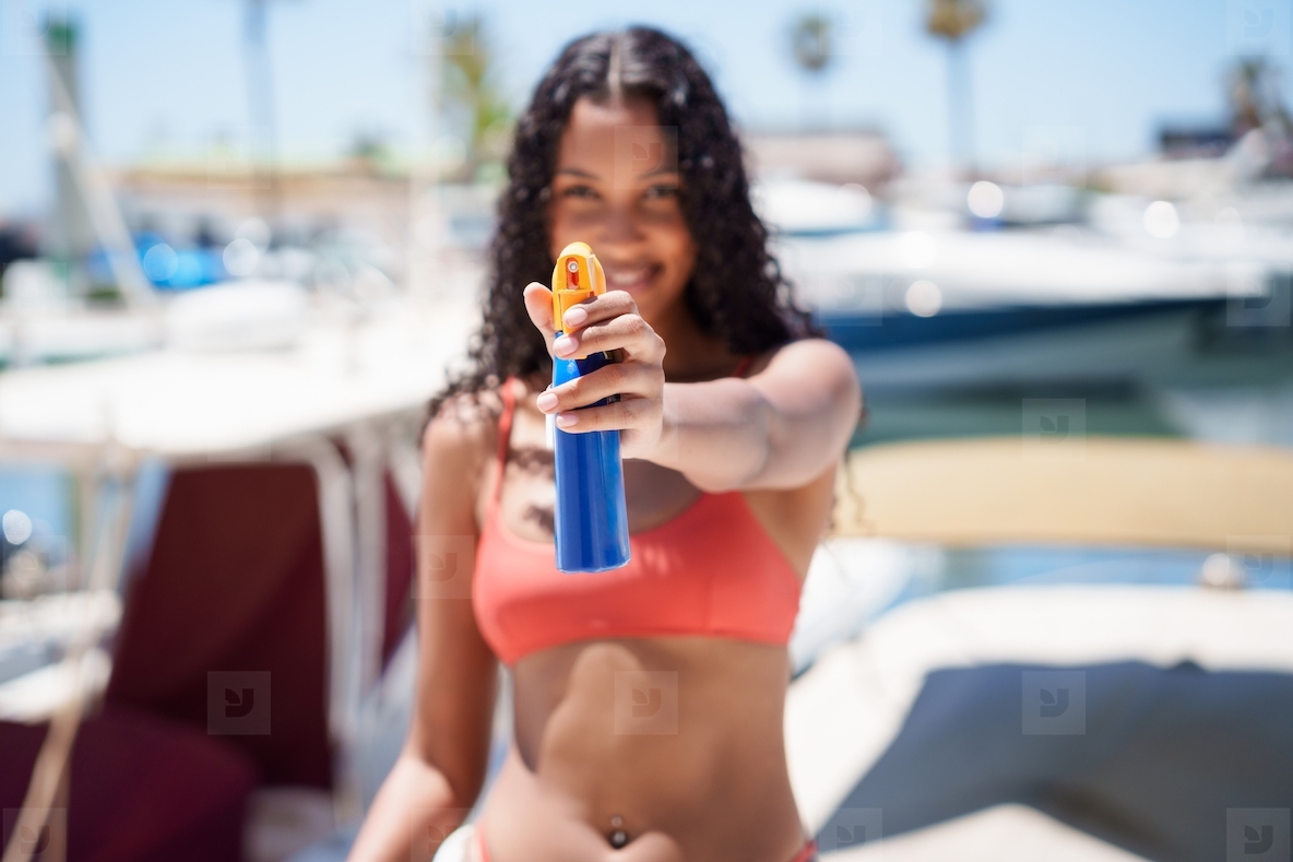 Happy Summer Vibes Woman Cheerfully Applying Sunscreen While Enjoying a Day on a Boat