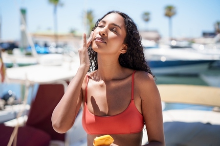 Joyful and Relaxing Summer Vibes A Young Woman Happily Enjoying a Snack by the Water