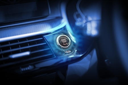 The car start button glows to indicate that it is ready to start