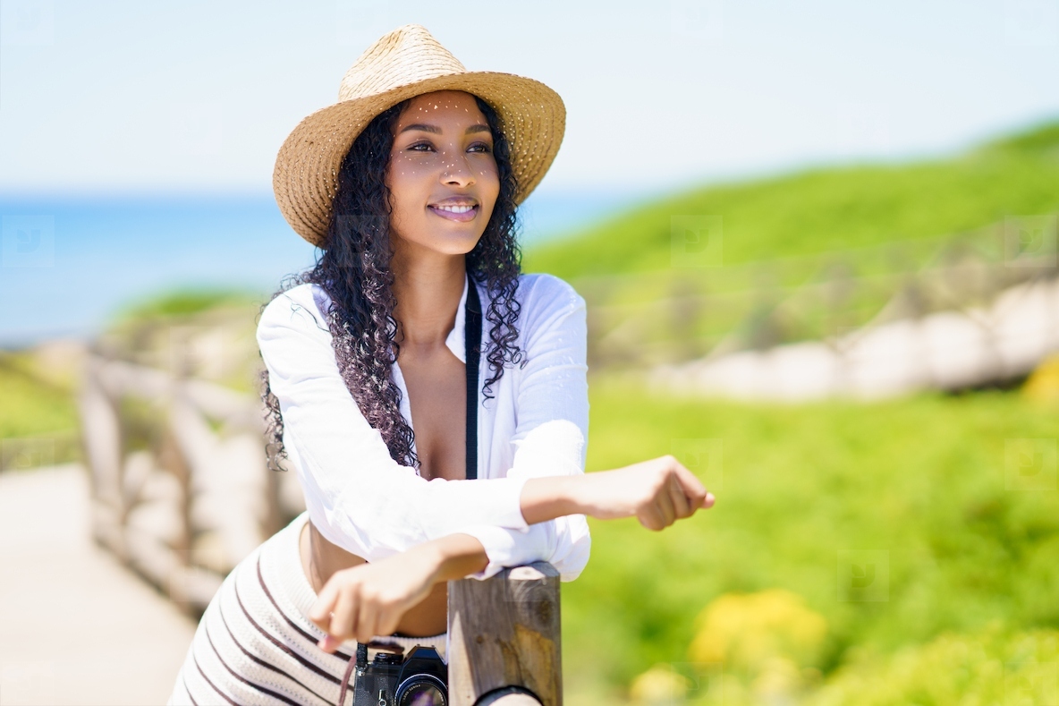 Cheerful Young Woman Enjoying a Wonderful Summer Day at the Beautiful Beach Setting