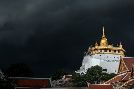 Golden mountain in Wat Saket Bangkok Thailand covered with dark Golden mountain in Wat Saket Bangkok Thailand covered with dark
