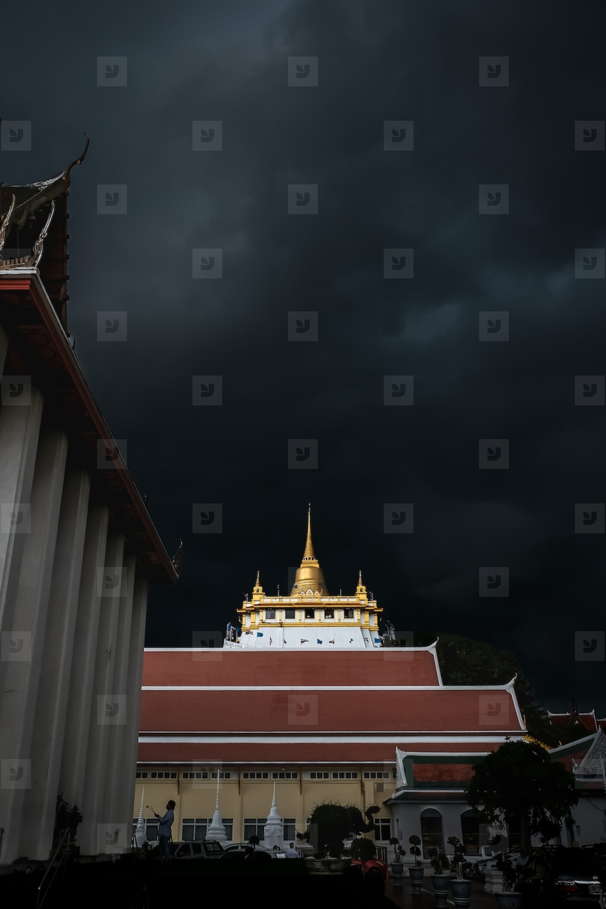 Golden mountain in Wat Saket Bangkok Thailand covered with dark