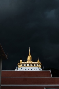Golden mountain in Wat Saket Bangkok Thailand covered with dark