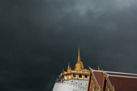 Golden mountain in Wat Saket Bangkok Thailand covered with dark
