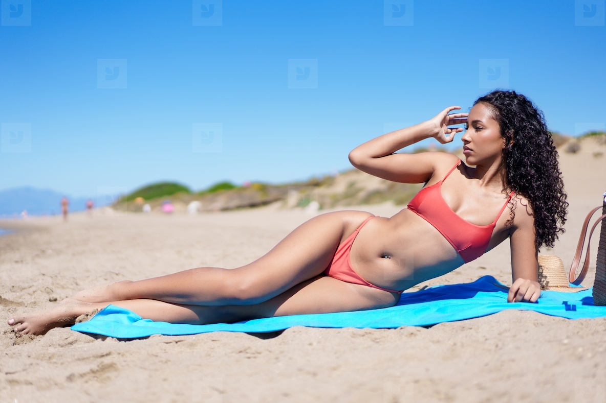 A Beautiful Woman Relaxing Peacefully on the Beach During a Wonderful Summer Day