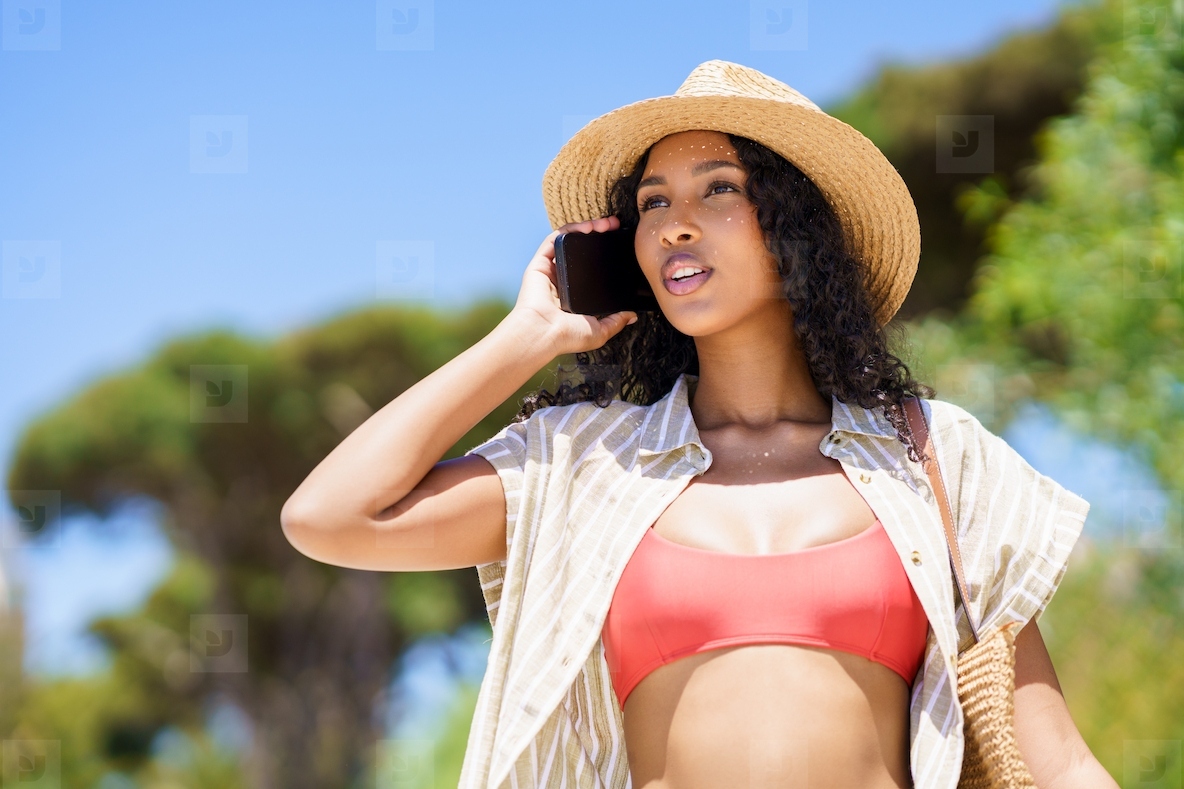 Summer Vibes A Woman Joyfully Enjoying a Wonderful Day at the Beach Under the Sun
