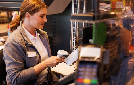 Female cashier scanning a barcode in a supermarket