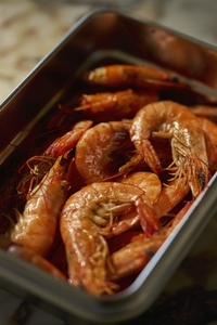 Still life high angle view container of cooked prawns