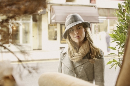 Stylish woman window shopping at boutique window