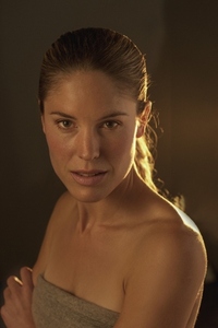 Portrait of beautiful woman with bare shoulders in golden light