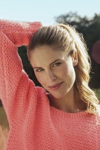 Portrait of smiling blond woman in pink sweater smiling in sunlight Portrait of smiling blond woman in pink sweater smiling in sunlight