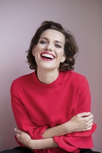 Portrait happy beautiful woman with short hair laughing against pink background
